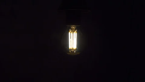 Old style lamp over black background, macro shot. 4k Stock Footage 105469652