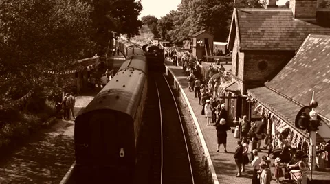 Old style shot of Steam train arriving into station Видео 39910735