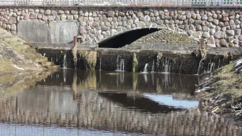 Old style stone bridge through a calm small river during the day Stock Footage 150863971