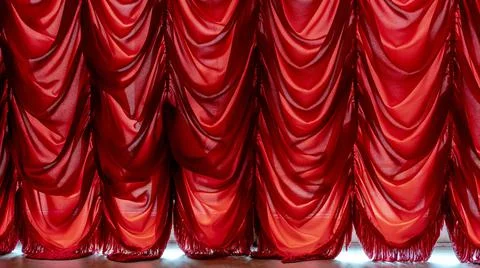 Old style translucent red curtain on window. Sunny light in house room. Stock Photos