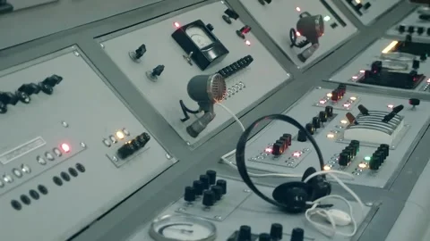 An old-style TV studio center console with microphones, knobs, buttons, gauges  動画素材 287956351