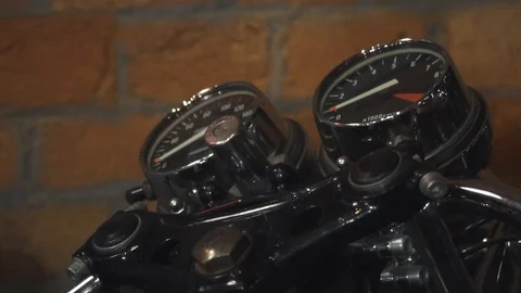 Old stylish motorcycle speedometer, tachometer stands in front of a brick wall 動画素材 101188829
