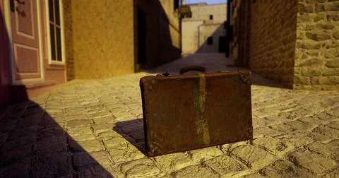 Old suitcase left on cobblestone street during golden hour in historic town Stock Illustration