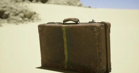 Old suitcase rests alone in an arid desert landscape under a clear sky Stock Illustration