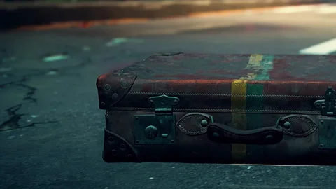 Old suitcase rests on the street during the day next to the sidewalk Vidéo 344303820