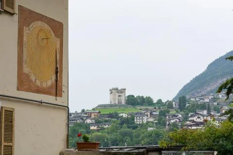 Old sun clock painted on a building wall. Stock Photos