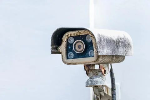 Old surveillance security camera mounted on wall, monitoring and protection.. Stock Photos