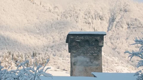 Old Svan defensive tower with steam rising from a chimney in winter, surrou.. Stock Footage 318356471