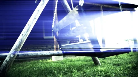 Old swing in the yard with light effect. weirdness Stock Footage 64790371