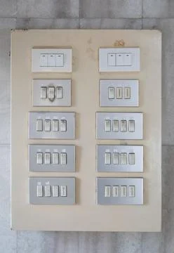 Old switch board installed on old marble wall Stock Photos