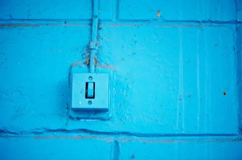 The old switch in the web on the blue brick wall Stock Photos