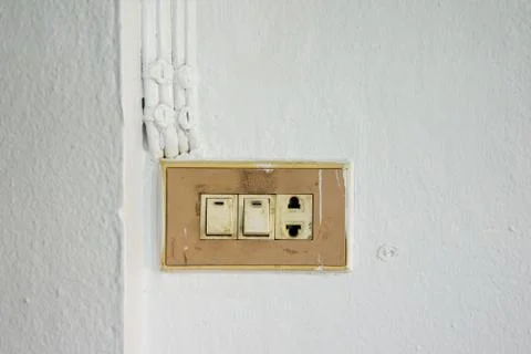 Old switch on white wall Stock Photos