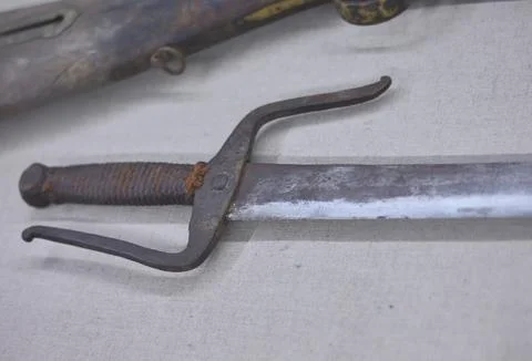 Old sword with worn handle on fabric Photos