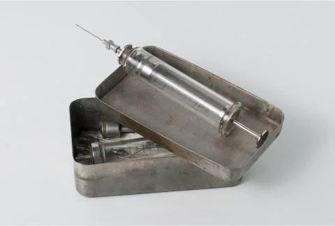 Old syringe with opened sterilizing box Stock Photos