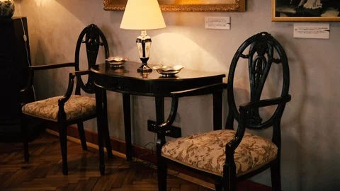 Old Table and two Chairs with a Lamp Stock-Footage 95777077