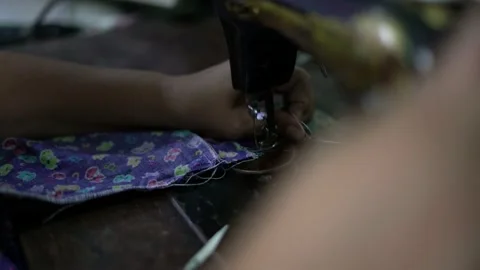 Old Tailor Hands Sewing Machine working from home during COVID-19 Coronavirus Video stock 143052826