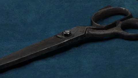 Old tailor scissors on blue fabric background Video stock 171564534