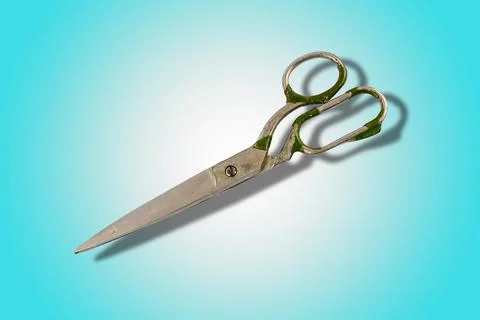 Old tailor scissors isolated on colored background. Vintage metal hand tools. Stock Photos