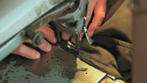 Old tailor works on his old sewing machine Stock Footage 147548614
