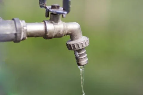 From an old tap water flows Stock Photos