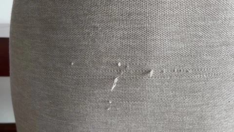 An old, tattered chair with drawstrings Moved the sofa and cause the scratches Stockbeeldmateriaal 322096232