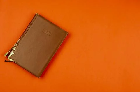An old tattered diary on a red background. Stock Photos