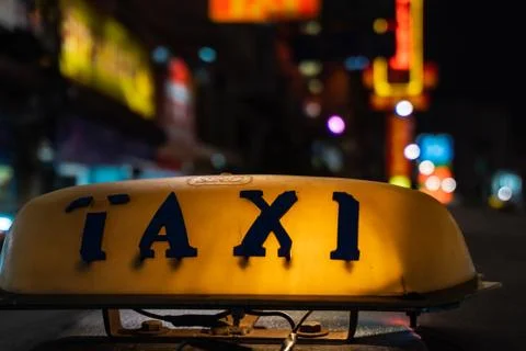Old taxi sign glowing in the dark, streets of Bangkok Stock Photos