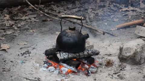 Old teapot boils on campfires Stock Footage 120335734