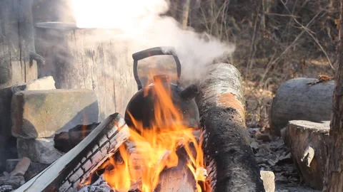 Old teapot boils on campfires Stock Footage 120335922