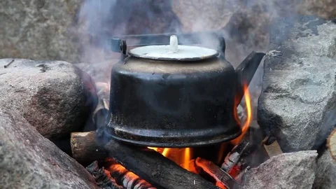 The old teapot boils on a marching fire Stock Footage 80282400