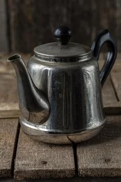 Old teapot on rustic kitchen table background Stock Photos