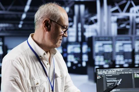 Old technician coding in data center Stock Photos