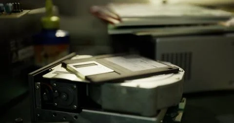 Old technology revival in a workspace showcasing a hard drive and floppy disk Stock Illustration