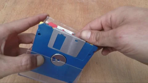 Old Technology - Sliding the write-protect tab on a Floppy Disk / Diskette Video stock 171074564