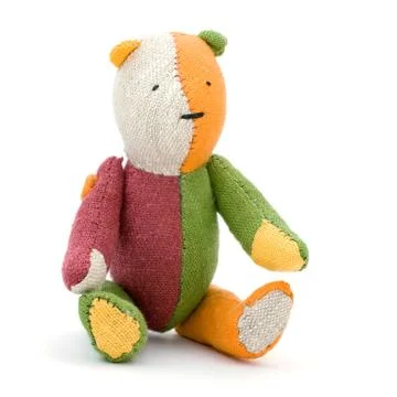 An old teddy bear on a white background. Stock Photos