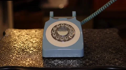 An old telephone on a metal table background with a male picking up the phone Stock Footage 164388927