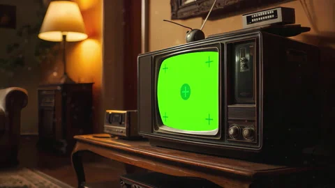 Old television displaying green screen chroma key in cozy vintage living room Stock Footage 304811087