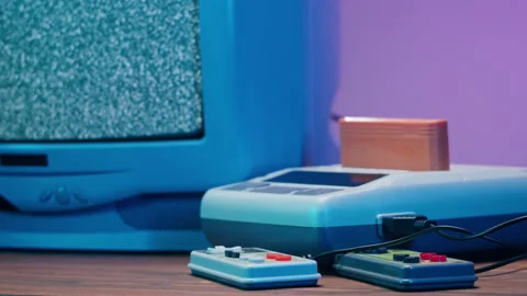 Old television with grey interference screen on purple neon background. Close-up Vidéo 168617872