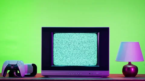 Old television with grey interference screen on green neon background. Close-up Stock Footage 168991313