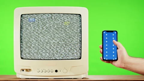 Old television with grey interference screen on green background and smartphone Stock-Footage 169199360