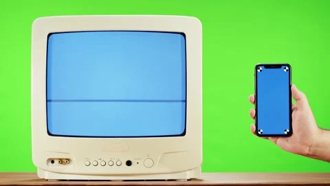 Old television with interference screen on green background and smartphone with Video stock 169195005