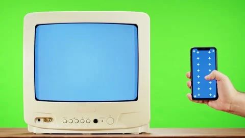 Old television with interference screen on green background and smartphone with Stock-Footage 169195185