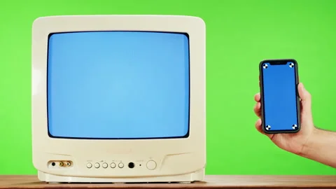 Old television with interference screen on green background and smartphone with Stock Footage 169196883