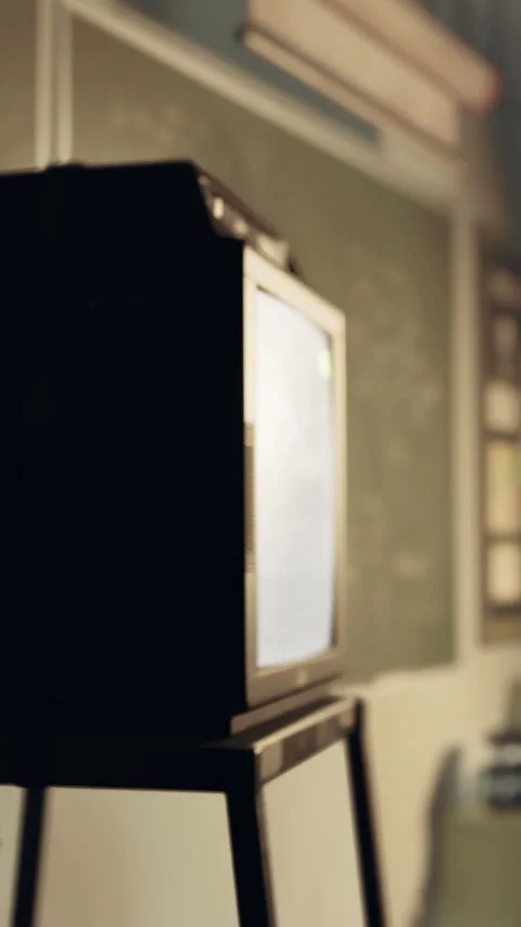 Old television is placed on a stand in a classroom setting during the day Stock Footage 340259938