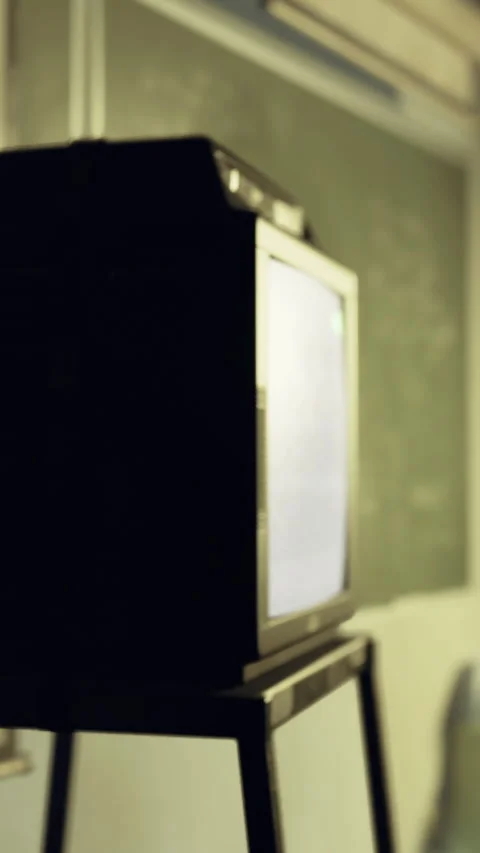 Old television on stand in classroom during lesson in school setting Stock Footage 330441082