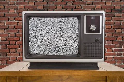 Old Television with Static Screen and Brick Wall Stock Photos
