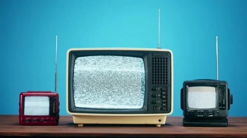 Old televisions with grey interference screen on blue background. Close-up of Video stock 169113970