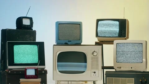 Old televisions with grey interference screen on light background. Vintage tv Stock Footage 169114128