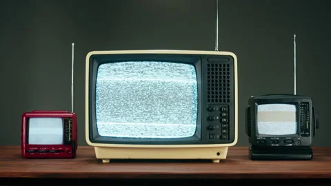 Old televisions with grey interference screen on black background. Close-up of 스톡 동영상 169309995