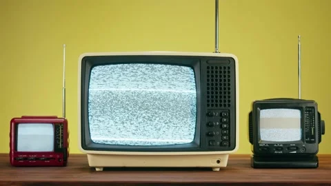 Old televisions with grey interference screen on yellow background. Close-up of Stock Footage 169373023